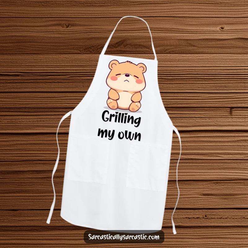 Funny bear apron showing a bear shrugging its shoulders with a faint, unimpressed smirk. Kitchen essential humor.