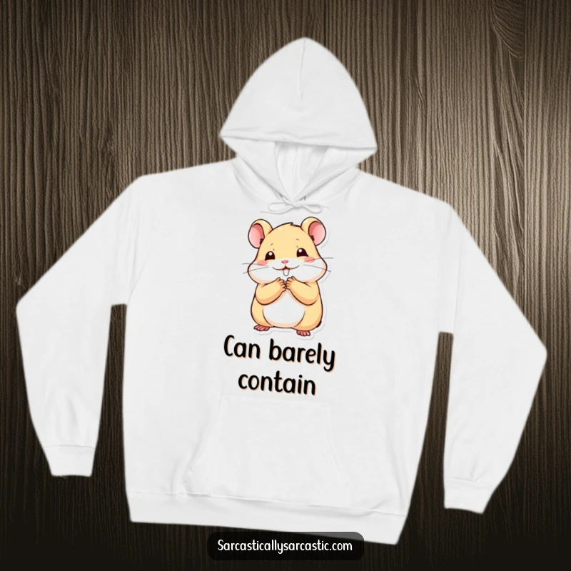 Funny kawaii hamster hoodie with a paw to mouth, stifling a smile, offering cozy comfort and a funny gift.